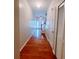Spacious hallway with hardwood floors leads to a staircase and exterior door for easy access at 523 Lantern Wood Dr, Scottdale, GA 30079