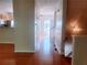 Inviting hallway with hardwood floors connects the home's spaces, creating a seamless flow and open feel at 523 Lantern Wood Dr, Scottdale, GA 30079