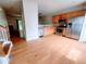 Open kitchen features stainless appliances, wooden cabinets and hardwood flooring at 523 Lantern Wood Dr, Scottdale, GA 30079
