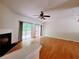Spacious living room featuring hardwood floors, a ceiling fan, and sliding doors that lead to an outdoor space at 523 Lantern Wood Dr, Scottdale, GA 30079