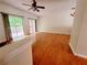 Bright living room with hardwood floors, ceiling fan and sliding glass doors to backyard deck at 523 Lantern Wood Dr, Scottdale, GA 30079
