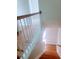 Wooden staircase with white railing leading to the second floor at 523 Lantern Wood Dr, Scottdale, GA 30079