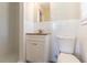Cozy bathroom features a single vanity, decorative countertop, neutral walls and tiled shower with white cabinets at 2062 Whites Mill Rd, Decatur, GA 30032