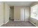 This bedroom has neutral paint, carpet, and a closet with a large window bringing in natural light at 2062 Whites Mill Rd, Decatur, GA 30032