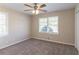 A carpeted bedroom features a ceiling fan and a large window providing natural light at 2062 Whites Mill Rd, Decatur, GA 30032