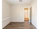 Room with wood floors and painted brick, has an open doorway and a view of a door at 2062 Whites Mill Rd, Decatur, GA 30032
