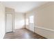 Room with wood floors and painted brick, has a closet, a window and an exterior door at 2062 Whites Mill Rd, Decatur, GA 30032