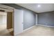 Neutral basement room with soft carpet, gray walls, and ample space at 2228 Arbor Forest Sw Trl, Marietta, GA 30064