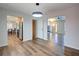 Bright dining room with wood floors, modern lighting, and seamless transition to kitchen and living space at 2228 Arbor Forest Sw Trl, Marietta, GA 30064