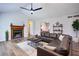 Spacious living room features vaulted ceilings, a ceiling fan, a brick fireplace, and wood flooring at 2228 Arbor Forest Sw Trl, Marietta, GA 30064