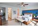 Bright main bedroom features hardwood floors, a blue paneled wall, and plenty of natural light at 2228 Arbor Forest Sw Trl, Marietta, GA 30064