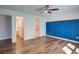 Bright main bedroom features hardwood floors, a blue paneled wall, and a walk-in closet at 2228 Arbor Forest Sw Trl, Marietta, GA 30064