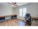 Office features hardwood floors, a ceiling fan, and a large window for plenty of natural light at 2228 Arbor Forest Sw Trl, Marietta, GA 30064