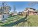 Large backyard view of home with detached garage and mature trees at 3189 Terramar Dr, Atlanta, GA 30341