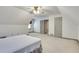 Bright attic bedroom has neutral tones, carpet, and a ceiling fan to ensure a restful environment at 3189 Terramar Dr, Atlanta, GA 30341