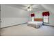 Attic bedroom with neutral walls and carpet features a ceiling fan and dormer windows at 3189 Terramar Dr, Atlanta, GA 30341