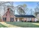 Charming brick home features mature trees, well-manicured lawn, and classic architectural details at 3189 Terramar Dr, Atlanta, GA 30341