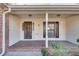 Charming front porch with brick floor and wooden front door offers classic curb appeal at 3189 Terramar Dr, Atlanta, GA 30341