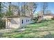 Detached garage with concrete driveway and mature trees in backyard at 3189 Terramar Dr, Atlanta, GA 30341