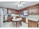 Traditional eat-in kitchen featuring wood cabinetry, white countertops, and white appliances at 3189 Terramar Dr, Atlanta, GA 30341