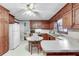 Traditional kitchen featuring wood cabinetry, white countertops and appliances, and room for a small table at 3189 Terramar Dr, Atlanta, GA 30341