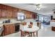 Traditional eat-in kitchen featuring wood cabinetry, white countertops, and an adjacent dining area at 3189 Terramar Dr, Atlanta, GA 30341