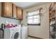 The laundry room has overhead cabinets and a window for natural light at 3189 Terramar Dr, Atlanta, GA 30341