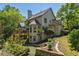 The house's back exterior has a deck, backyard access, manicured landscaping, and a private feel at 320 N Drew Ct, Duluth, GA 30097