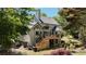 Charming backyard with a spacious deck, stairs, and a lush landscaped garden area at 320 N Drew Ct, Duluth, GA 30097