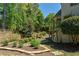 Landscaped backyard featuring a mini-golf course with trees and lush greenery that enhance privacy and beauty at 320 N Drew Ct, Duluth, GA 30097