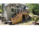 Inviting backyard with a wooden deck, stairs, and a lush landscaped garden area at 320 N Drew Ct, Duluth, GA 30097