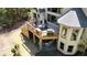 Outdoor living space featuring an elevated deck, a covered patio, and lush landscaping with mature trees at 320 N Drew Ct, Duluth, GA 30097