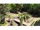 Lush backyard featuring mature trees, a small wooden bridge, and colorful plantings with ample privacy at 320 N Drew Ct, Duluth, GA 30097
