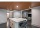 Stylish wet bar area with white countertops, barstool seating and dark floors at 320 N Drew Ct, Duluth, GA 30097