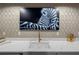 Marble countertop with a sink and bar accessories with a zebra art television in the background at 320 N Drew Ct, Duluth, GA 30097