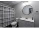 Gray bathroom with a white vanity and a gray and white striped shower curtain at 320 N Drew Ct, Duluth, GA 30097