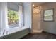 Bright bathroom featuring a soaking tub, subway tile shower, and a large window view at 320 N Drew Ct, Duluth, GA 30097