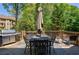 Spacious deck with large table, barbecue grill and outdoor seating, surrounded by mature trees at 320 N Drew Ct, Duluth, GA 30097