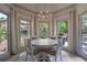 Charming dining area surrounded by windows and featuring a stylish chandelier at 320 N Drew Ct, Duluth, GA 30097