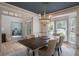 Dining room with a large dark wood table, upholstered chairs, and a large bay window at 320 N Drew Ct, Duluth, GA 30097