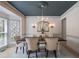 Elegant dining room featuring a chandelier, wainscoting, and a large window view at 320 N Drew Ct, Duluth, GA 30097