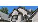 Elegant brick home with a symmetrical facade and striking architectural details with black shutters at 320 N Drew Ct, Duluth, GA 30097