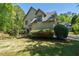 Well-maintained home exterior with lush landscaping and lawn with mature trees and shrubs for added privacy at 320 N Drew Ct, Duluth, GA 30097