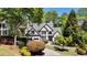 Charming two-story brick home featuring a two-car garage and landscaped front yard at 320 N Drew Ct, Duluth, GA 30097