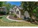 Charming home exterior shows landscaped yard, stone accents, and architectural details at 320 N Drew Ct, Duluth, GA 30097