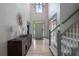 Light-filled foyer with hardwood floors, staircase, and statement light fixture at 320 N Drew Ct, Duluth, GA 30097