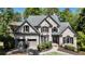 Traditional brick home with a well-manicured lawn and a two-car garage at 320 N Drew Ct, Duluth, GA 30097