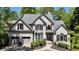 Traditional brick home with a well-manicured lawn and a two-car garage at 320 N Drew Ct, Duluth, GA 30097