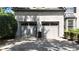 Spacious two-car garage with traditional doors, adjacent to a well-maintained brick exterior and tidy landscaping at 320 N Drew Ct, Duluth, GA 30097