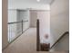 Upstairs hallway with a view to a large window and a staircase with railing at 320 N Drew Ct, Duluth, GA 30097